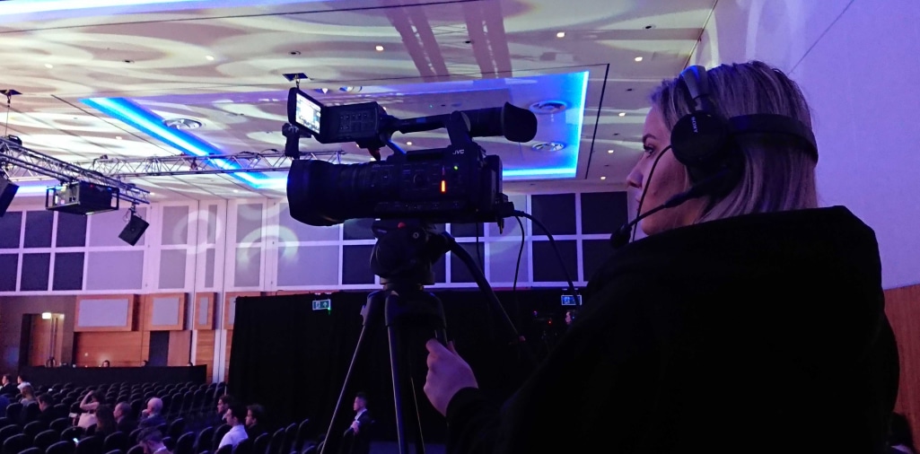 Camera operator live streaming at a large conference